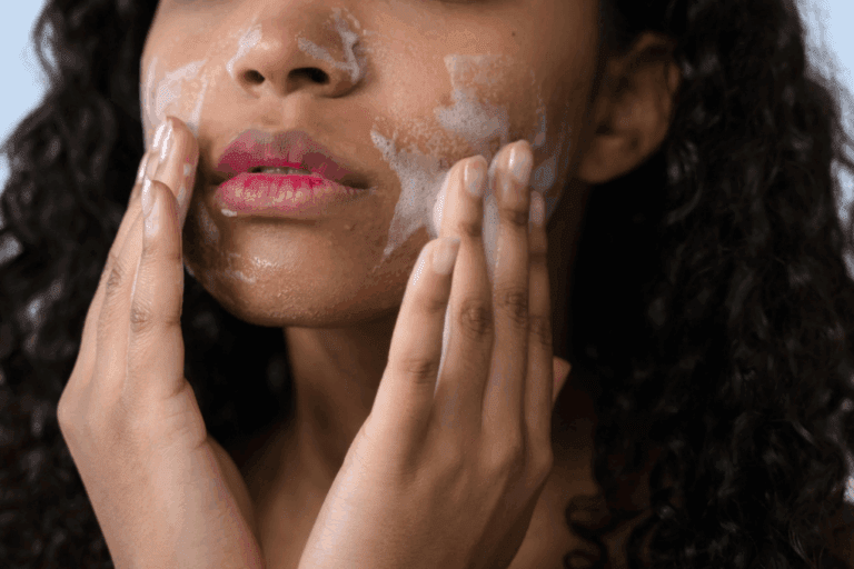 Woman with mild acne washes face with foaming face wash