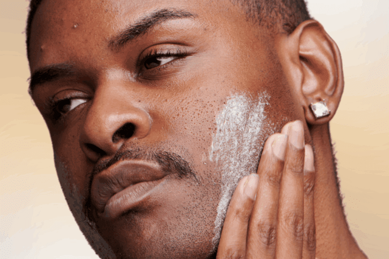 Man applying thick cream to face